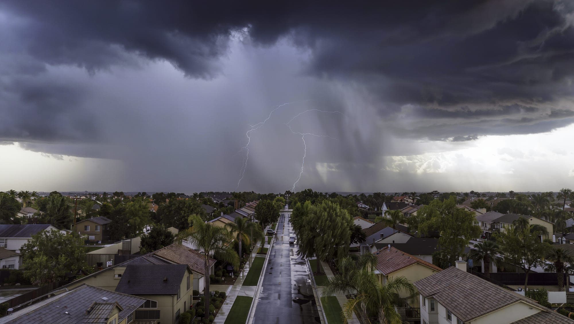 California homeowner reviewing roof insurance claim documents